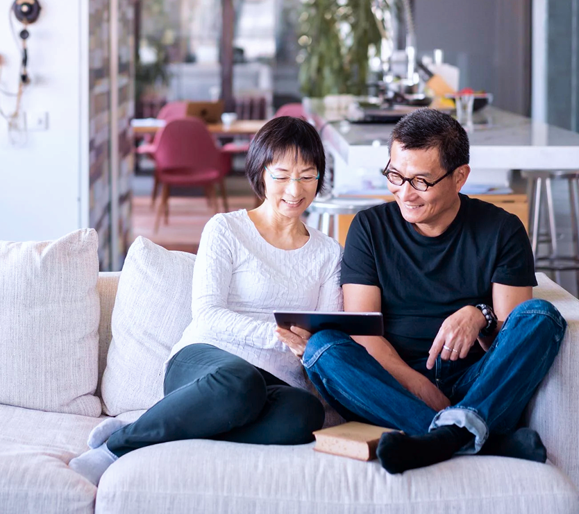 man and woman looking at tablet