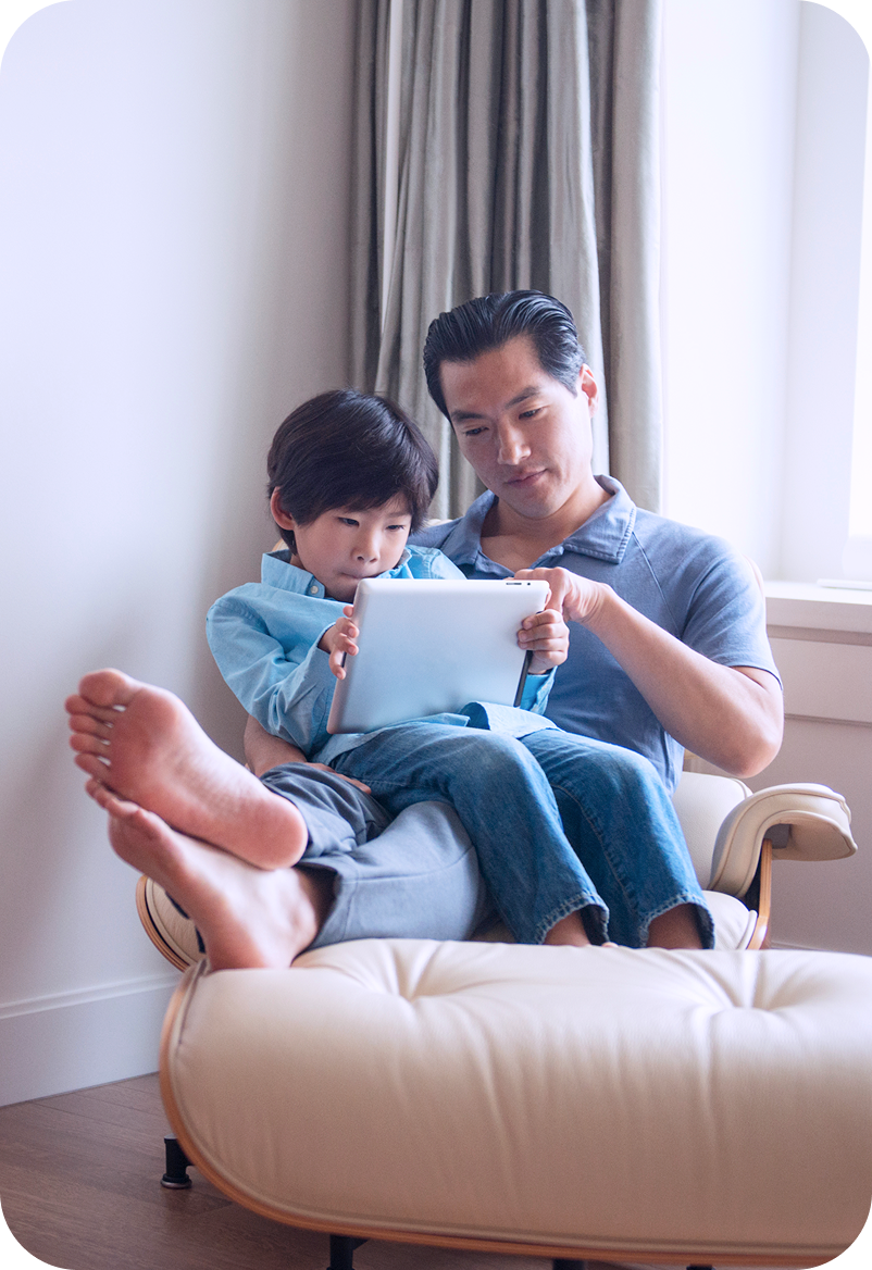 Father and son with tablet at home