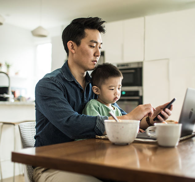 man and child on phone and laptop
