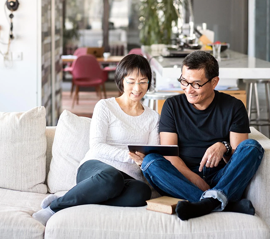 man and woman looking at tablet