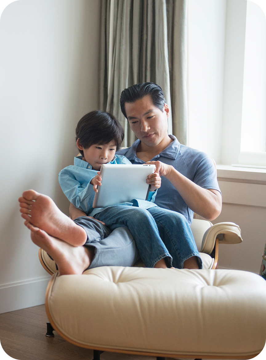Father and son with tablet at home